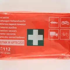 Pomarańczowa apteczka samochodowa z białym krzyżem i ikonami pojazdów.